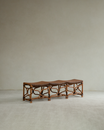 Wave-edged rattan bench with woven seat and curved openwork legs