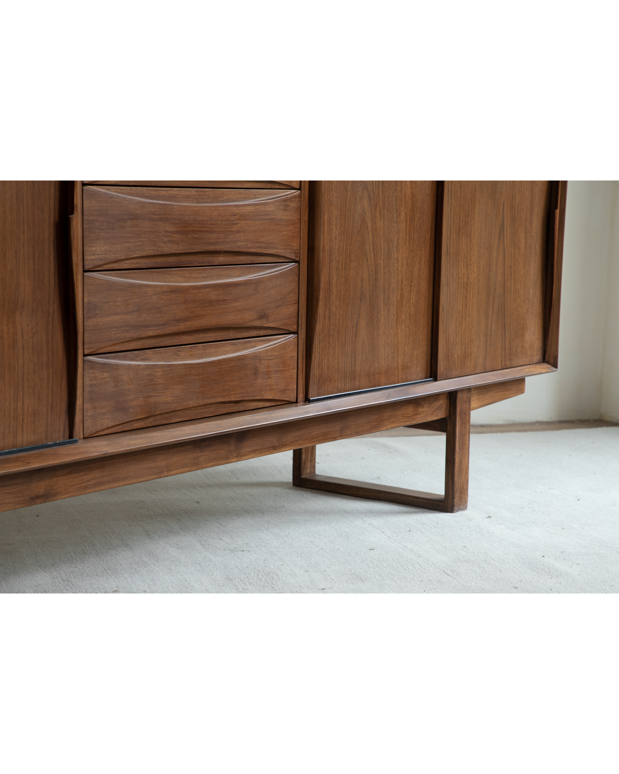 No.454 Sideboard with warm teak veneer and wave drawer fronts on angled legs.