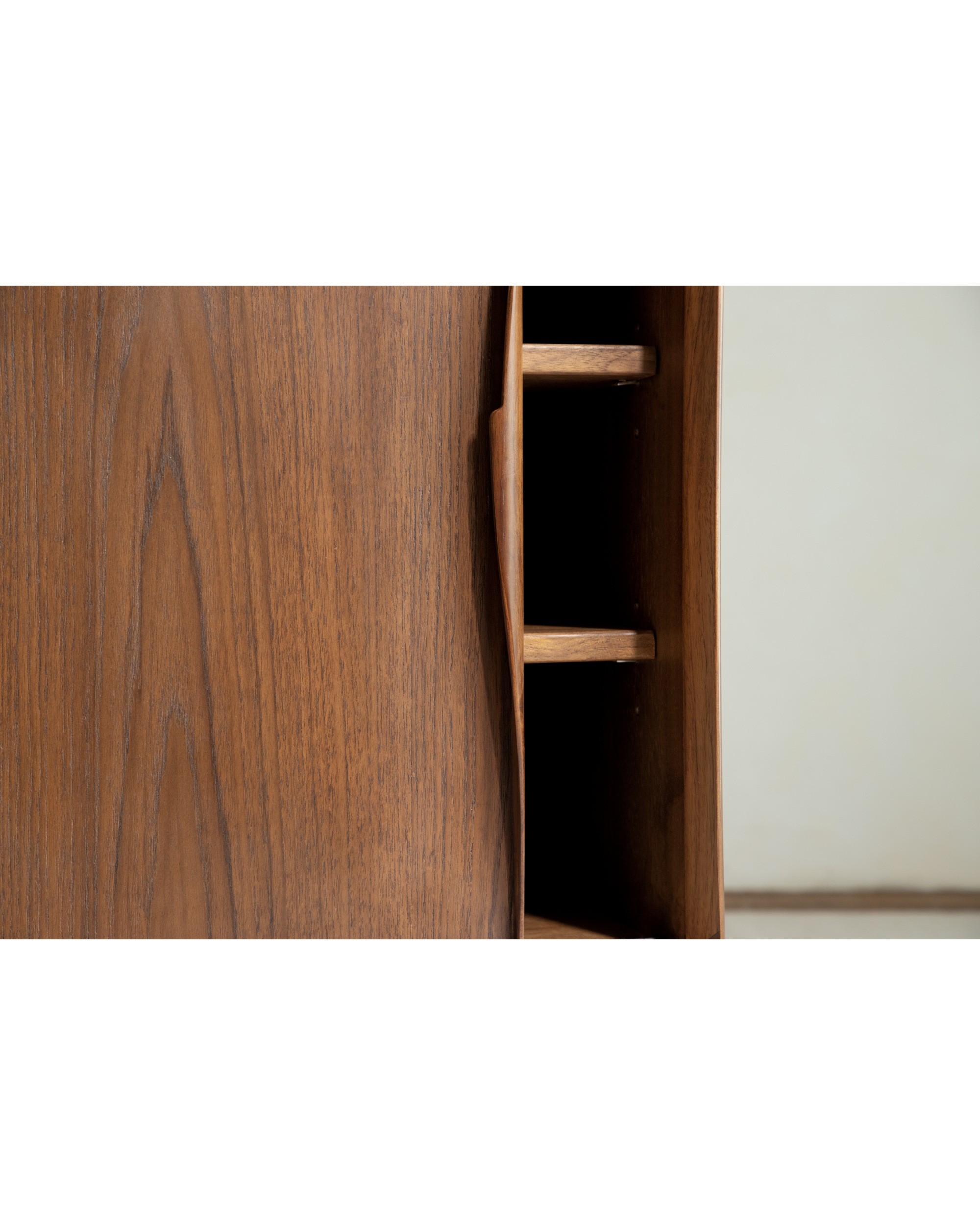 No.454 sideboard detail: teak veneer, integrated curved handle, and open shelf storage.