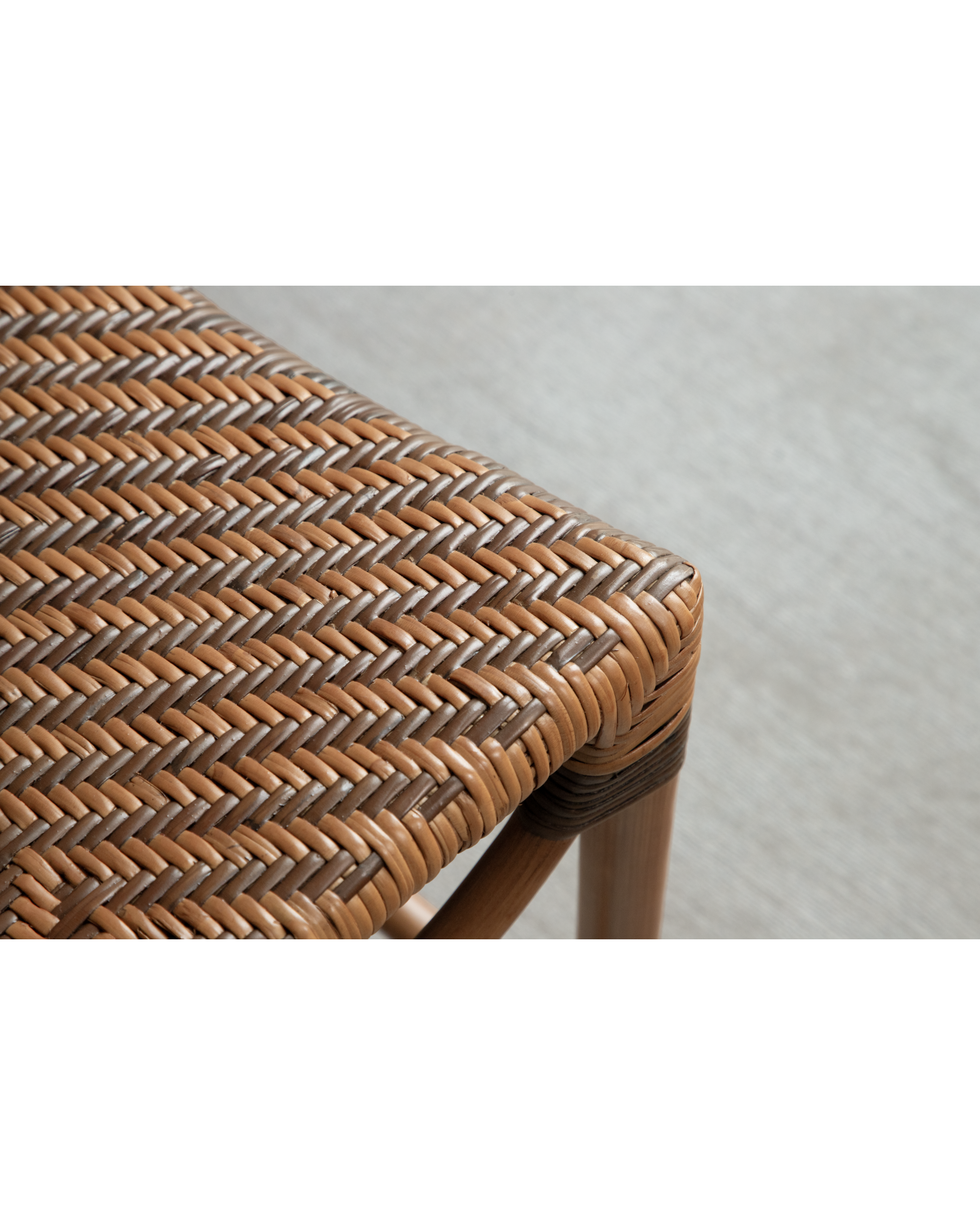 Close-up of Melange Bench woven rattan seat with dual-tone herringbone pattern
