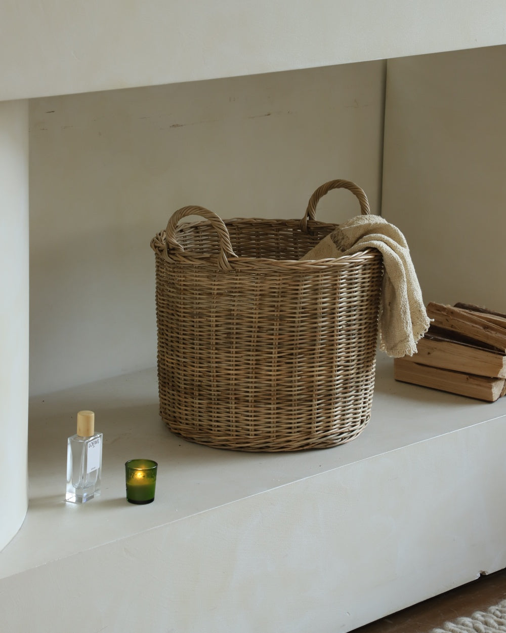 Aria Storage Basket, hand-woven natural rattan round basket with handles.