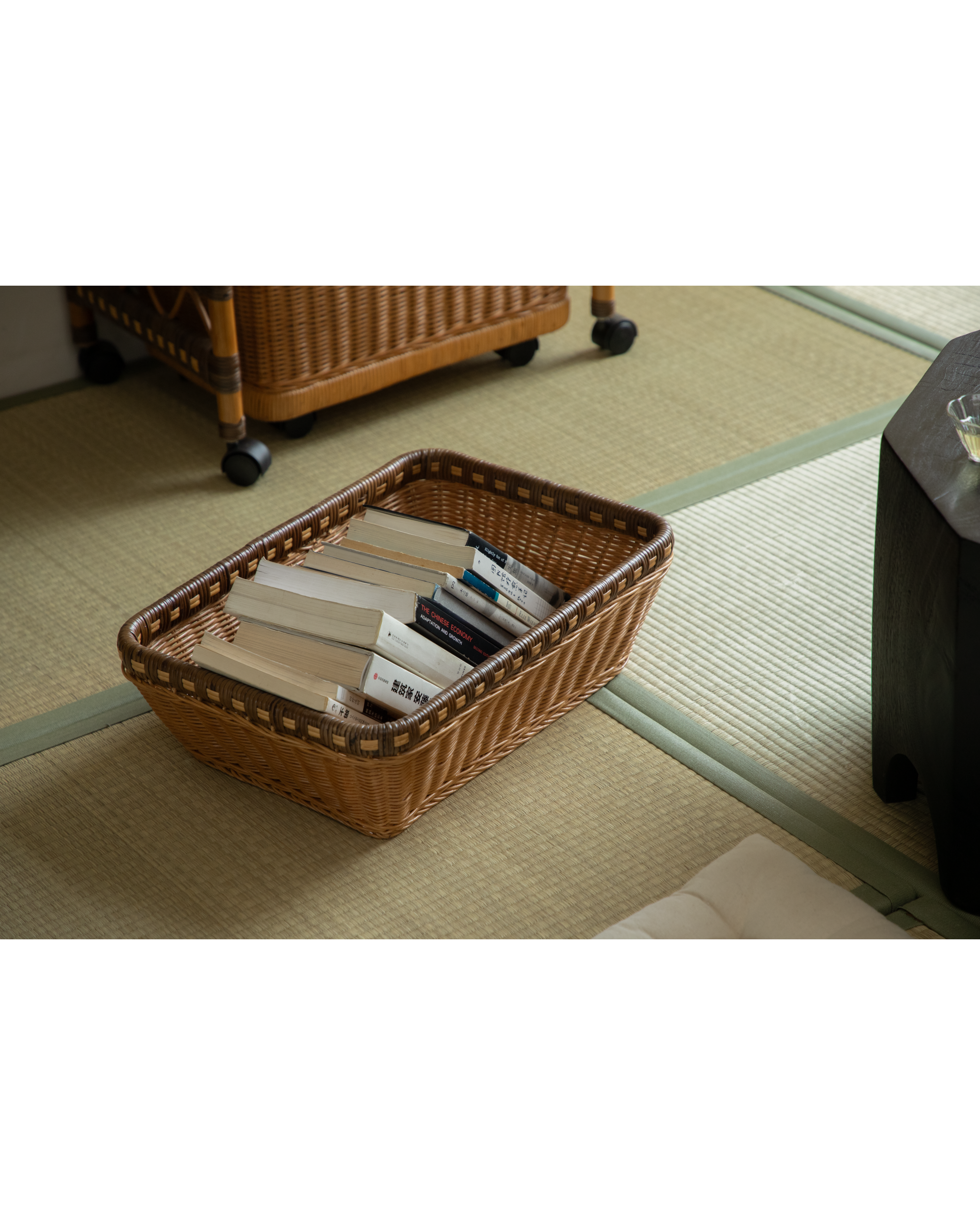 Milo Rattan Laundry Cart displaying books; versatile, natural woven storage.