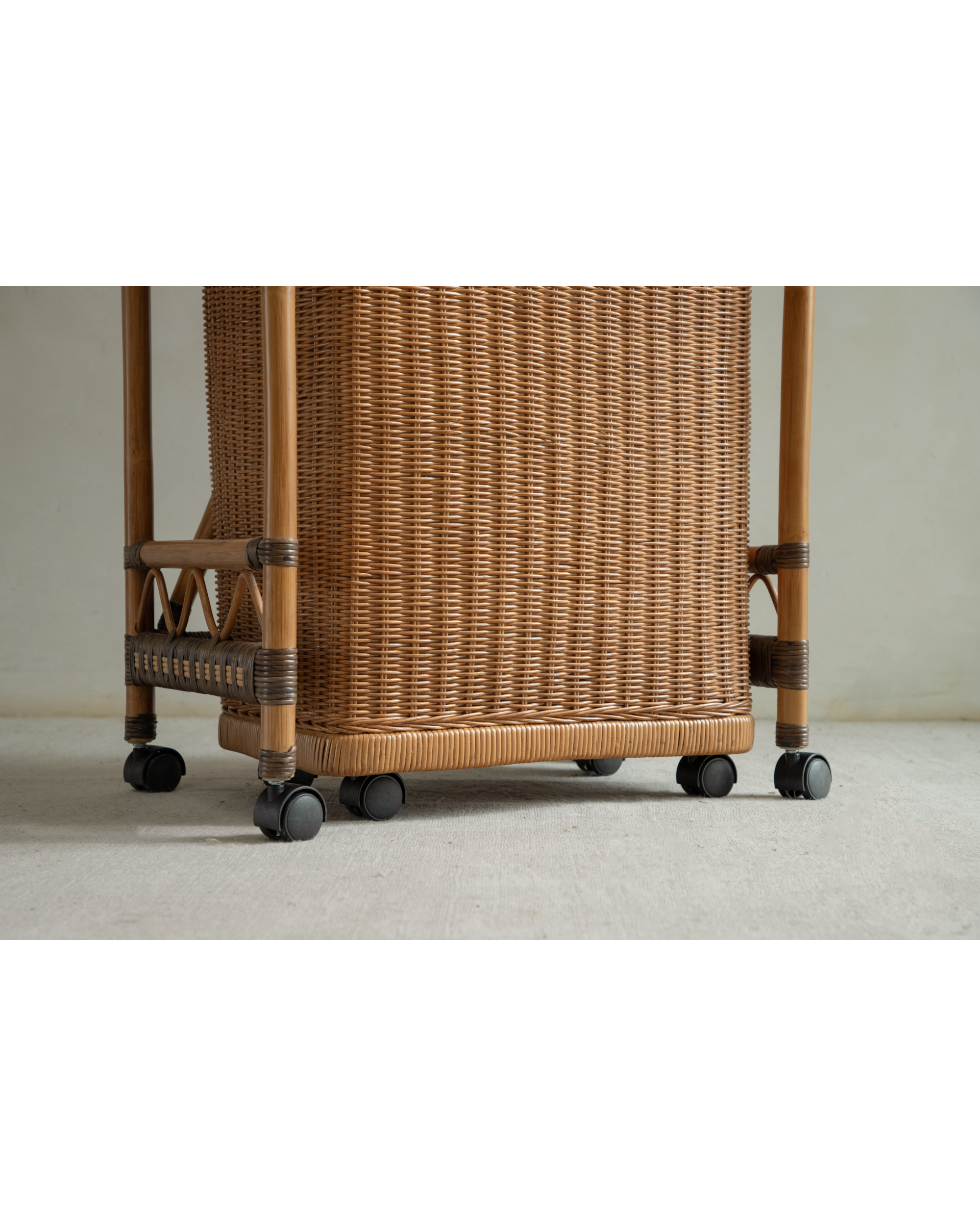 Milo Rattan Laundry Cart base with woven texture and black casters