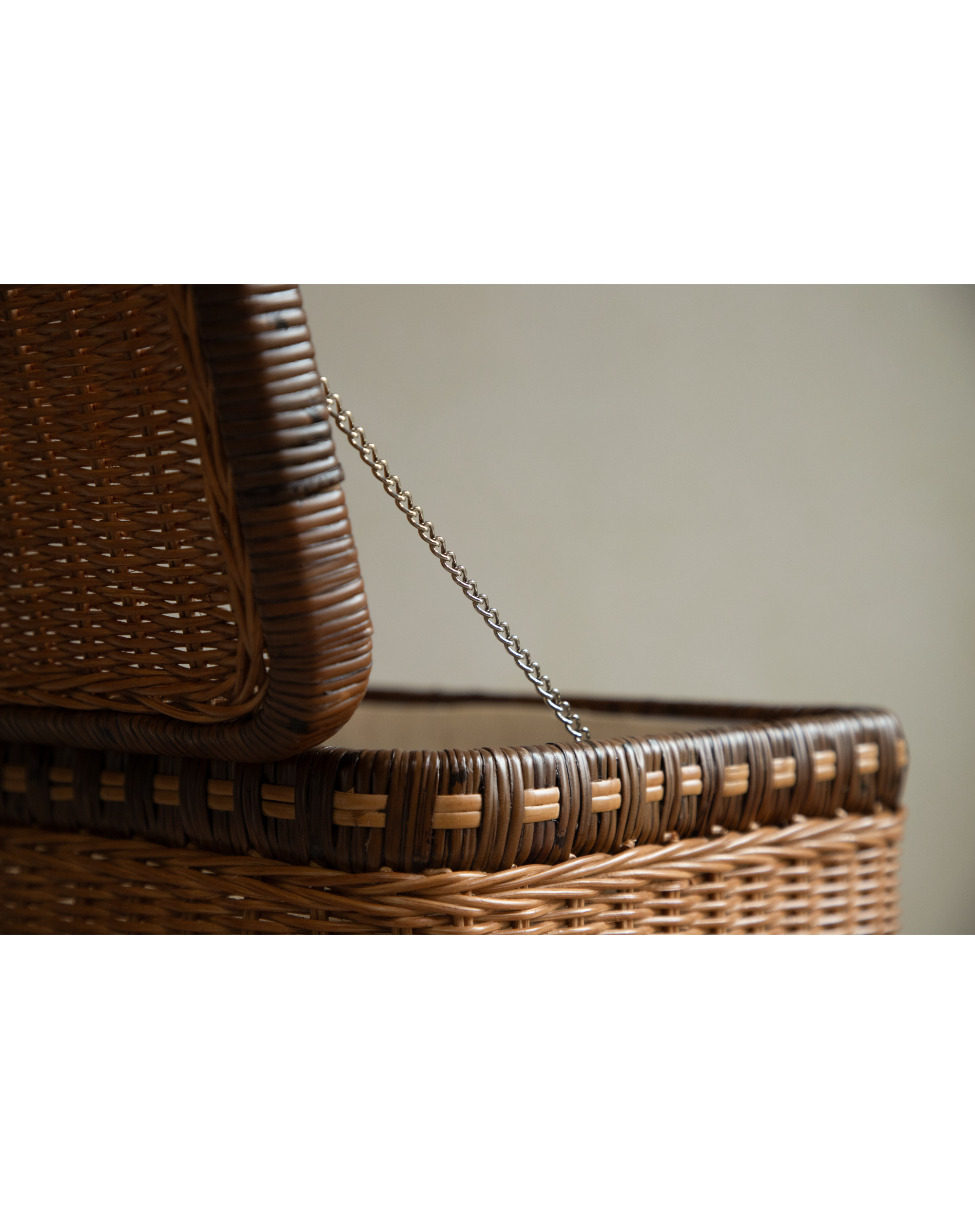 Milo Rattan Laundry Cart: Close-up showing woven rattan texture and metal chain.
