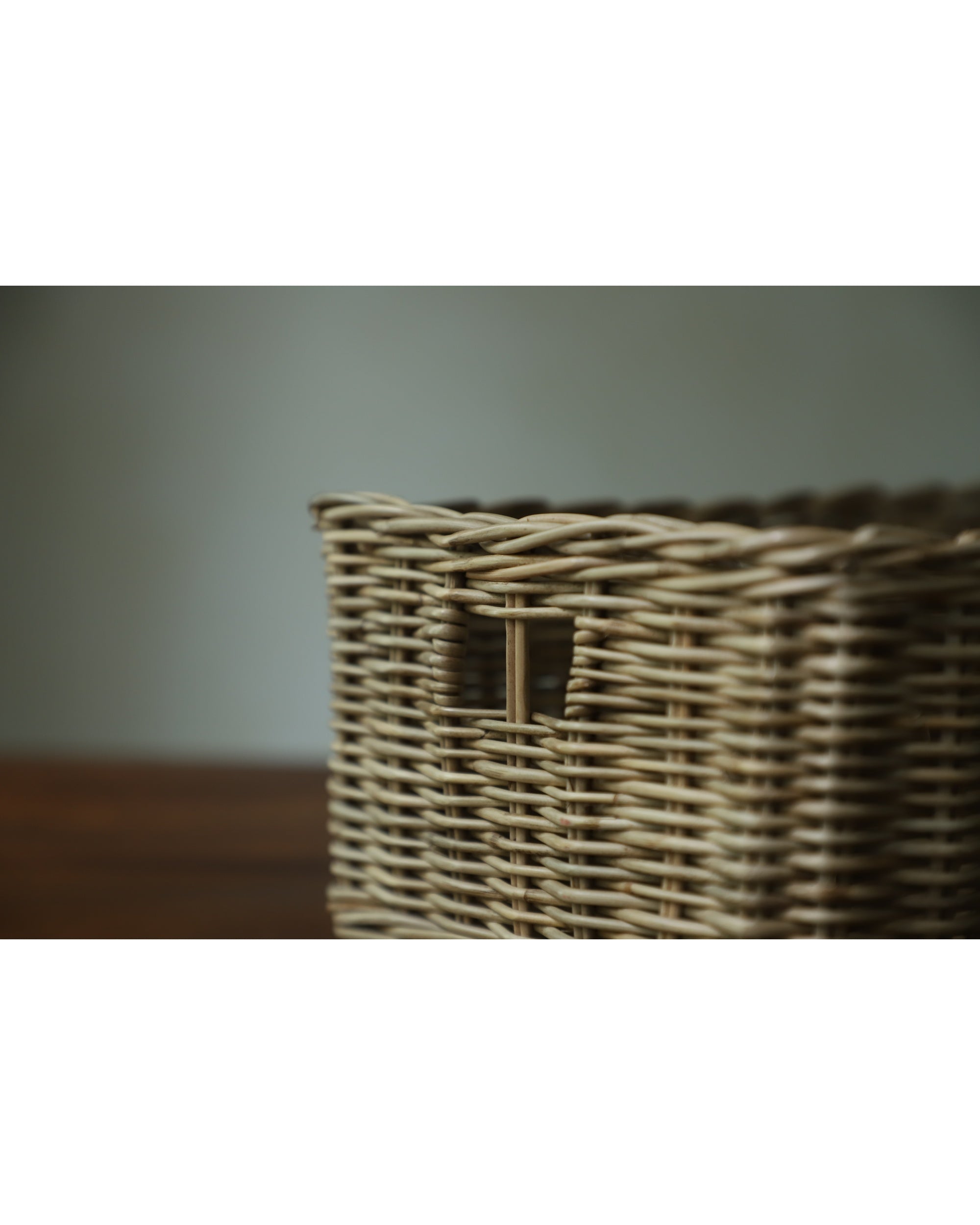 Etta natural rattan storage basket with woven texture and cutout handle