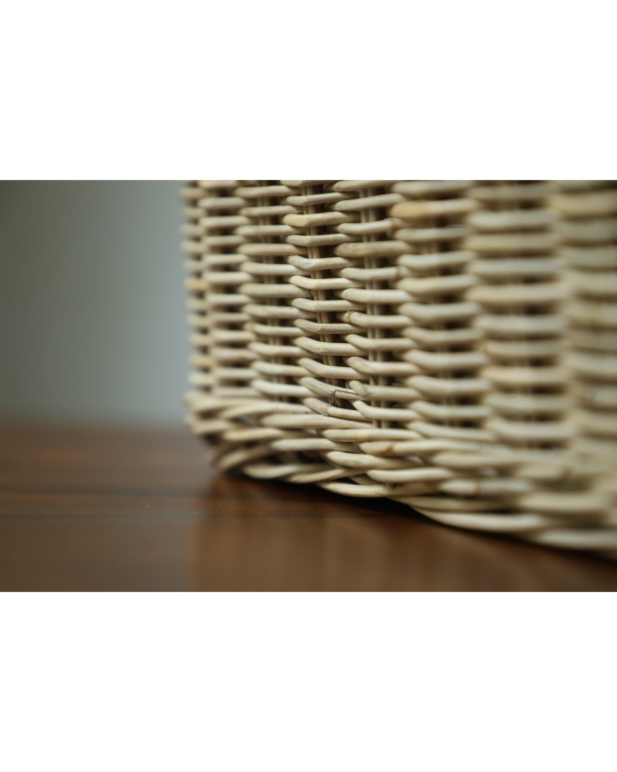 Close-up of hand-woven natural rattan Etta Storage Basket texture.