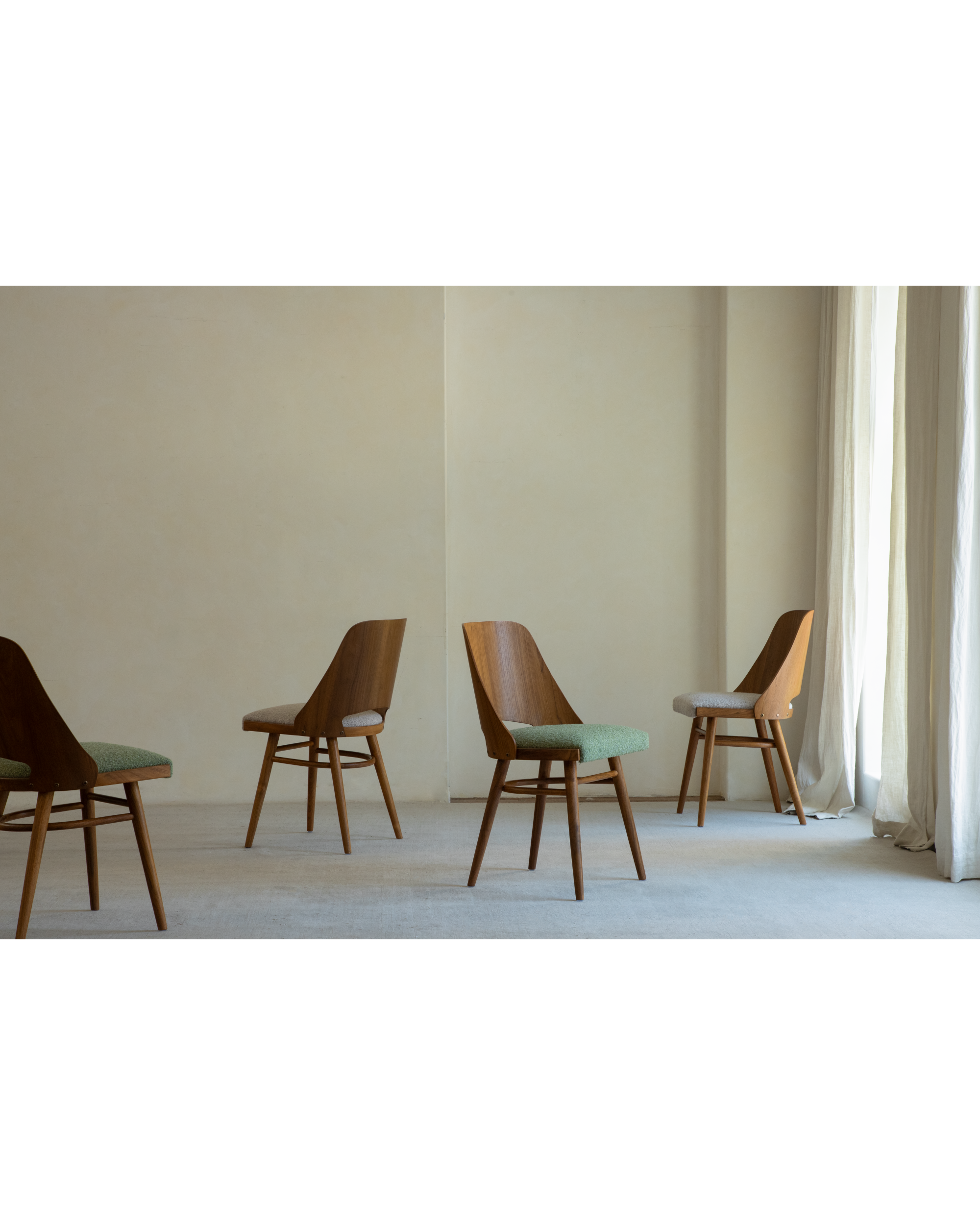 Teak wood Shell Chairs with green and light gray upholstered seats in a room setting.