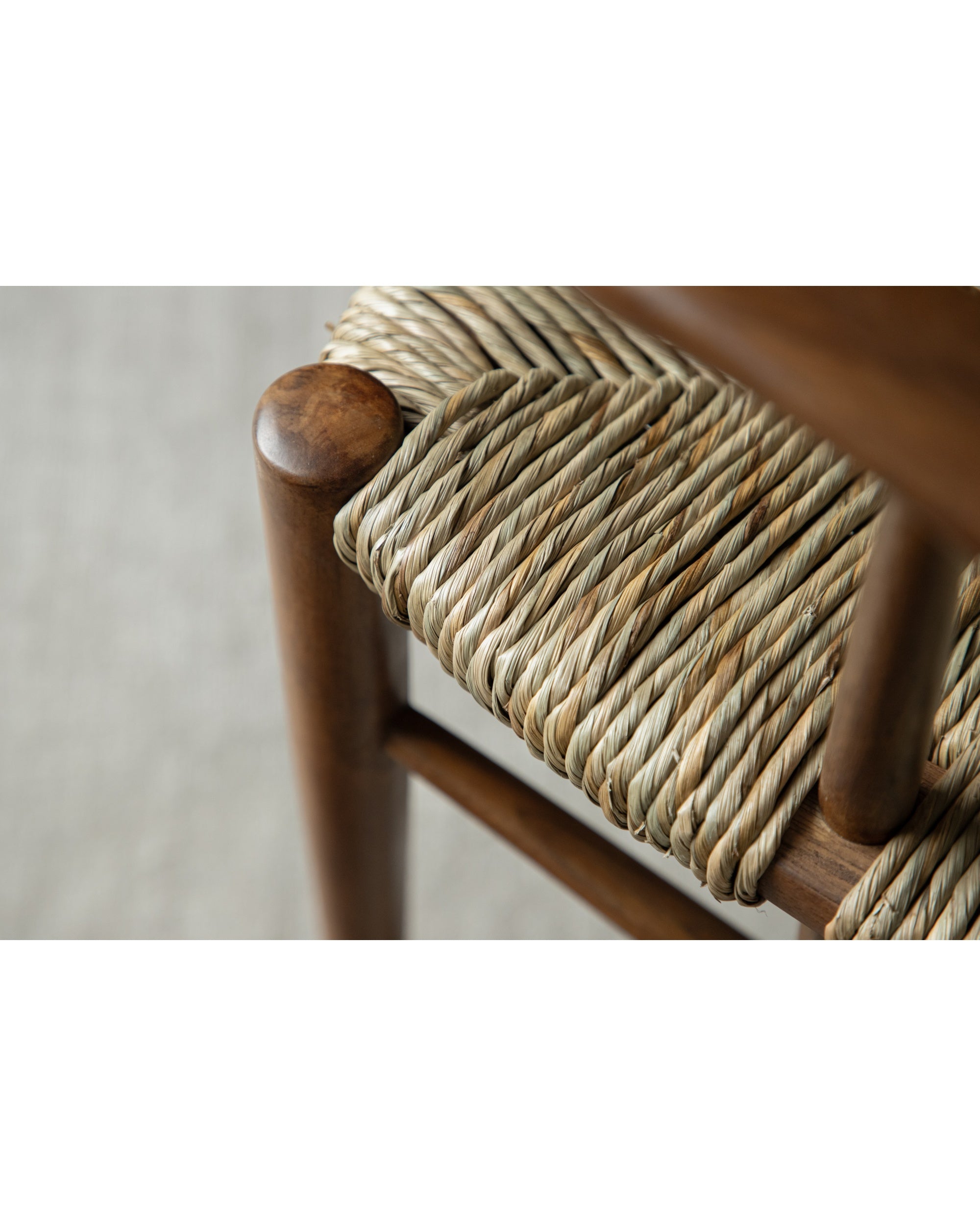 Henrik Dining Chair: close-up of woven rush seat and wooden frame detail.