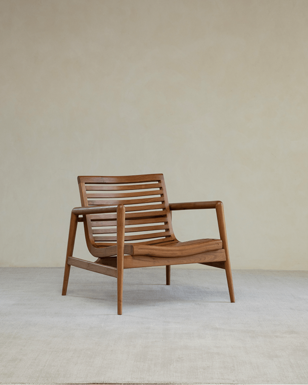 Teak wood garden lounge chair with slatted back and armrests, modern design