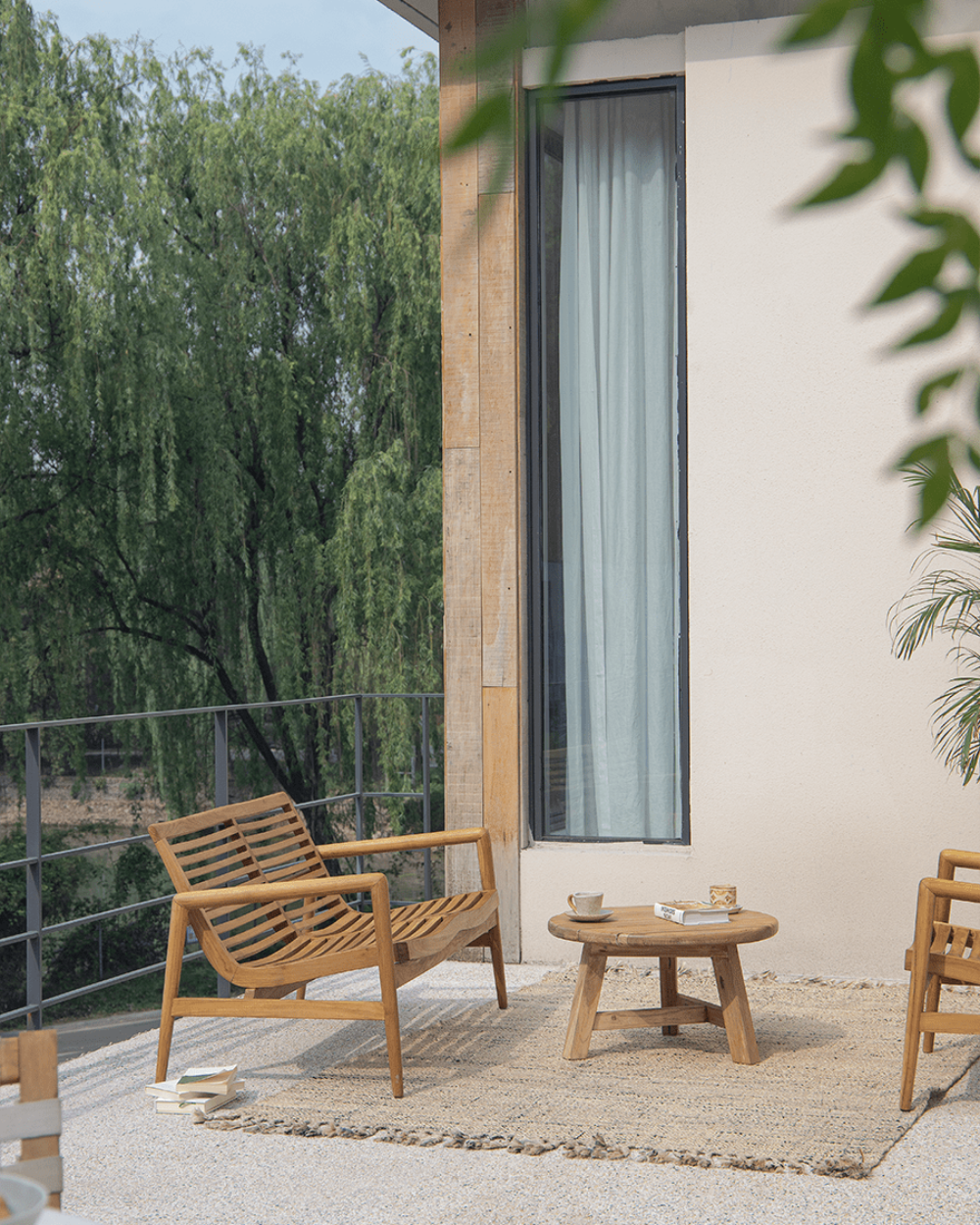 Teak wood garden lounge chair with slatted design, outdoor patio furniture, modern design, and wooden table