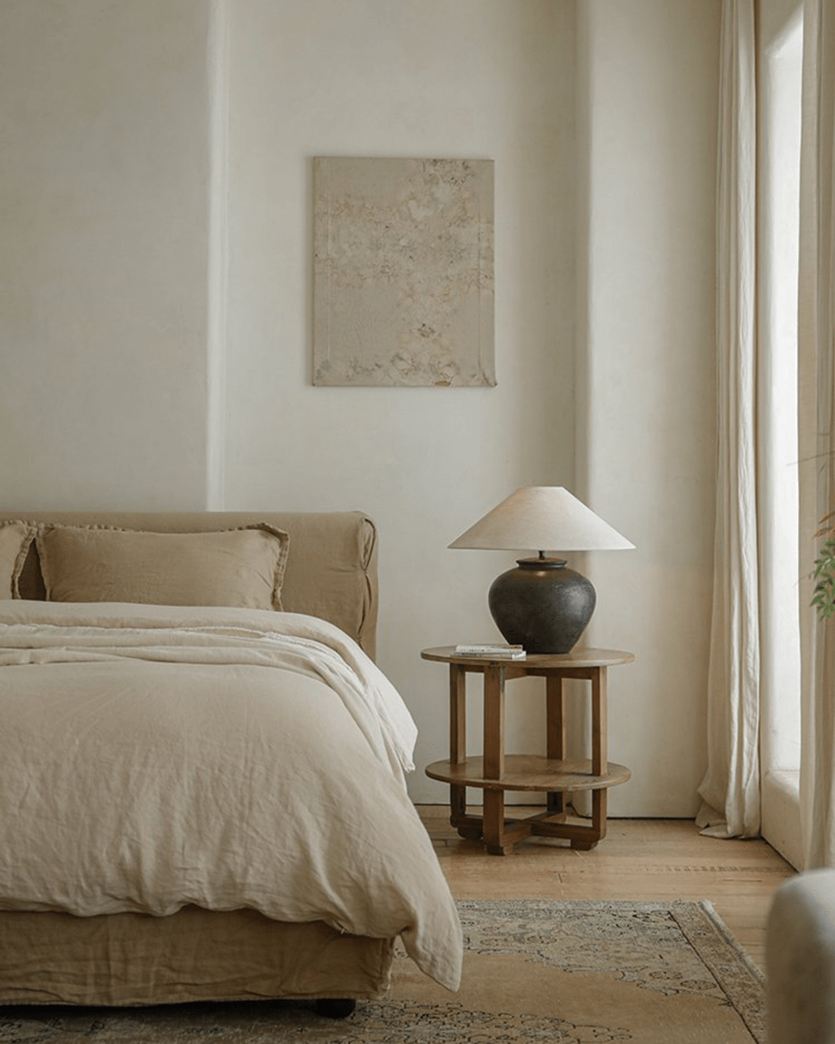 Clay Moon Lamp bedside table with beige lampshade in a cozy bedroom setting