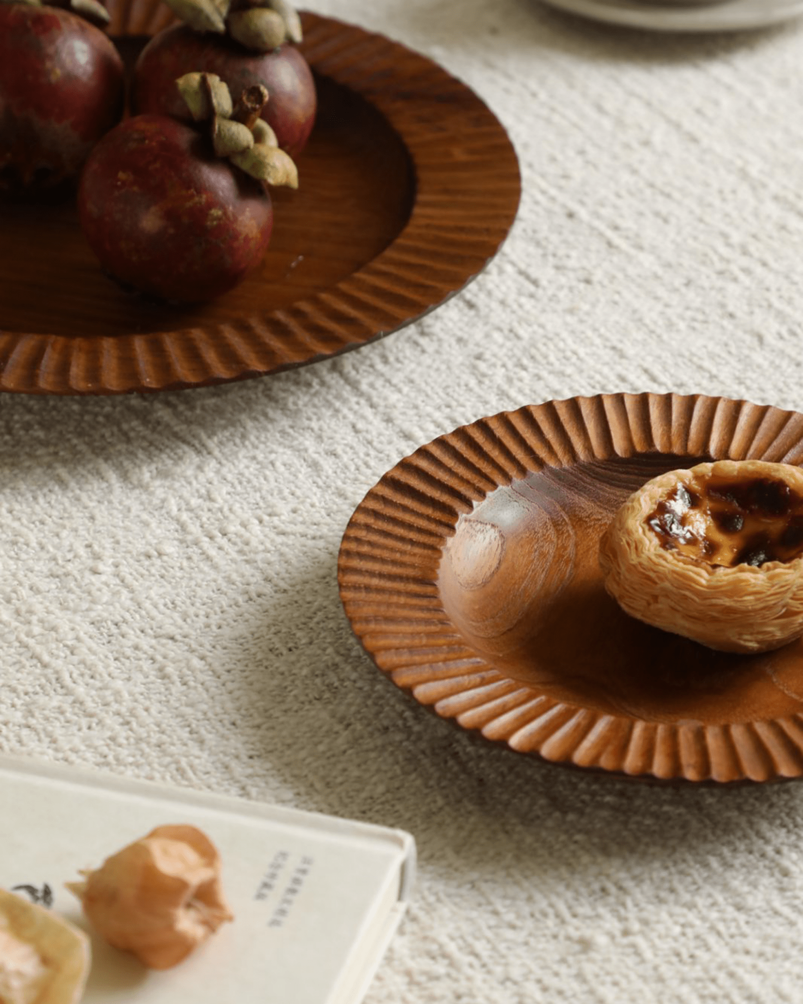 Handmade teak wood lace plate with mangosteens and egg tart. Indonesian plates for elegant dining.