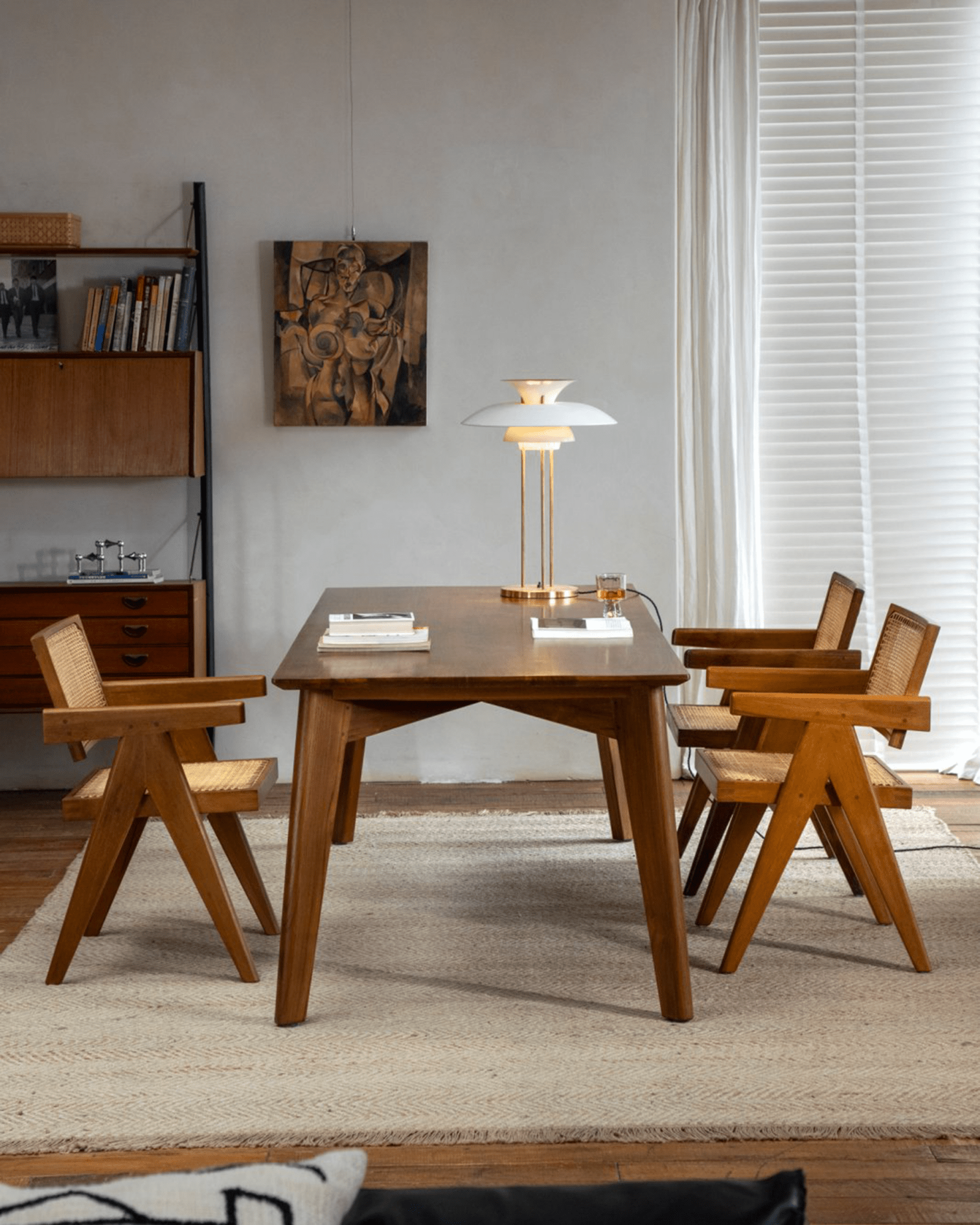 Easy Dining Table in a minimalist dining room setting, featuring African teak table, wooden chairs, and modern decor.