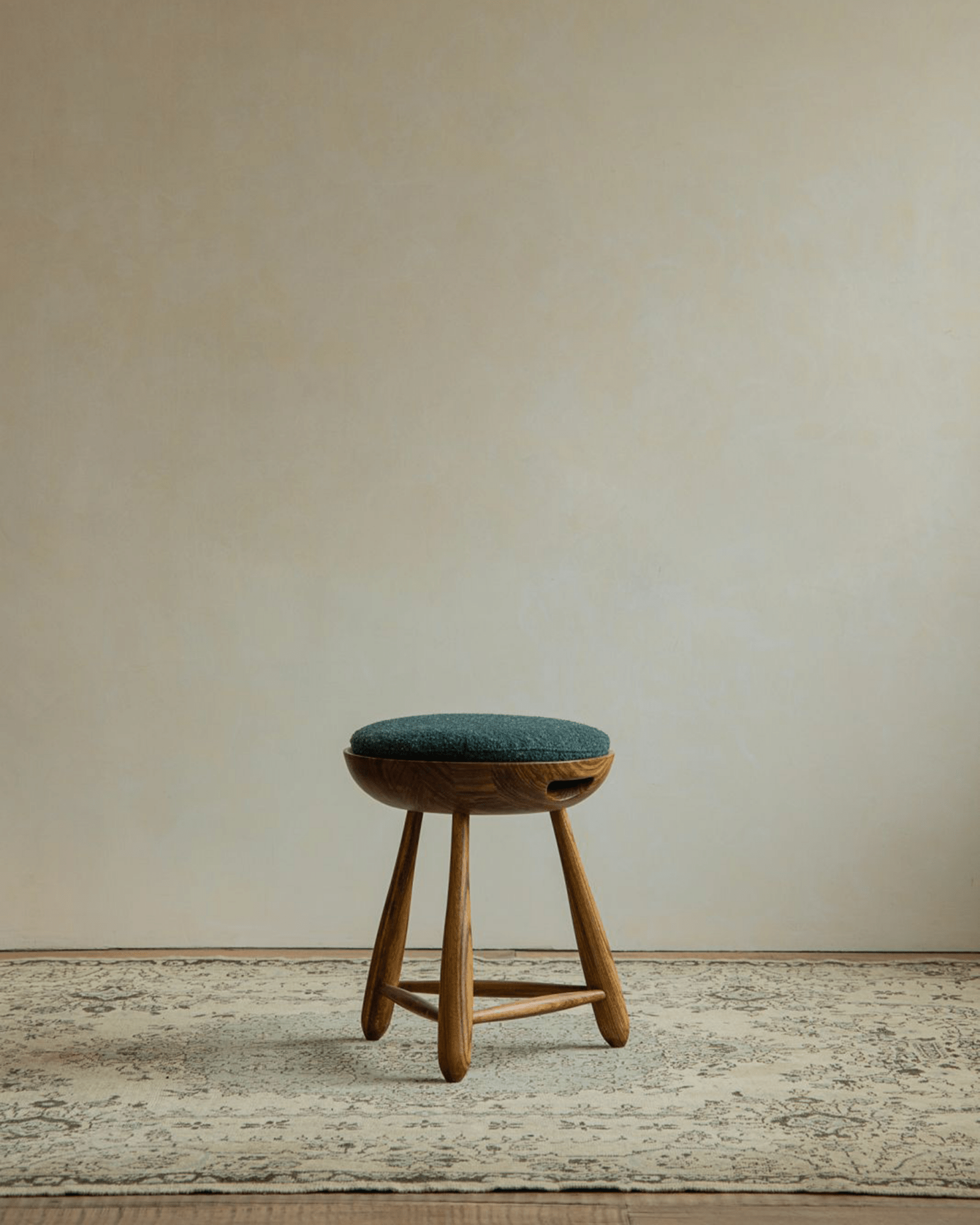 Zebrawood Mocho stool with teal cushion, organic design, tripod legs. Ideal for modern interiors.