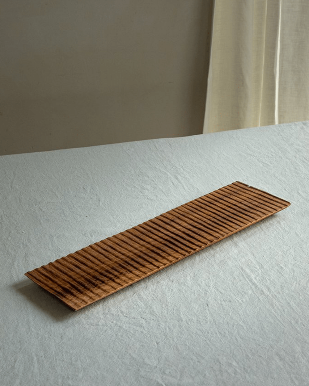 Handcrafted teak wood serving tray with textured surface, perfect for food display