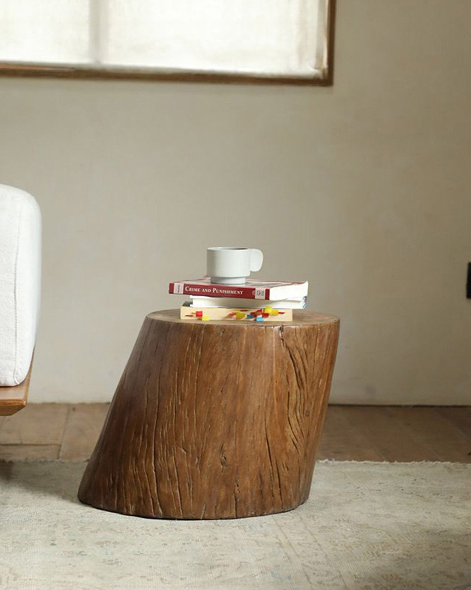 Alva Side Table in natural wood with books and a coffee cup, featuring organic design for modern interiors