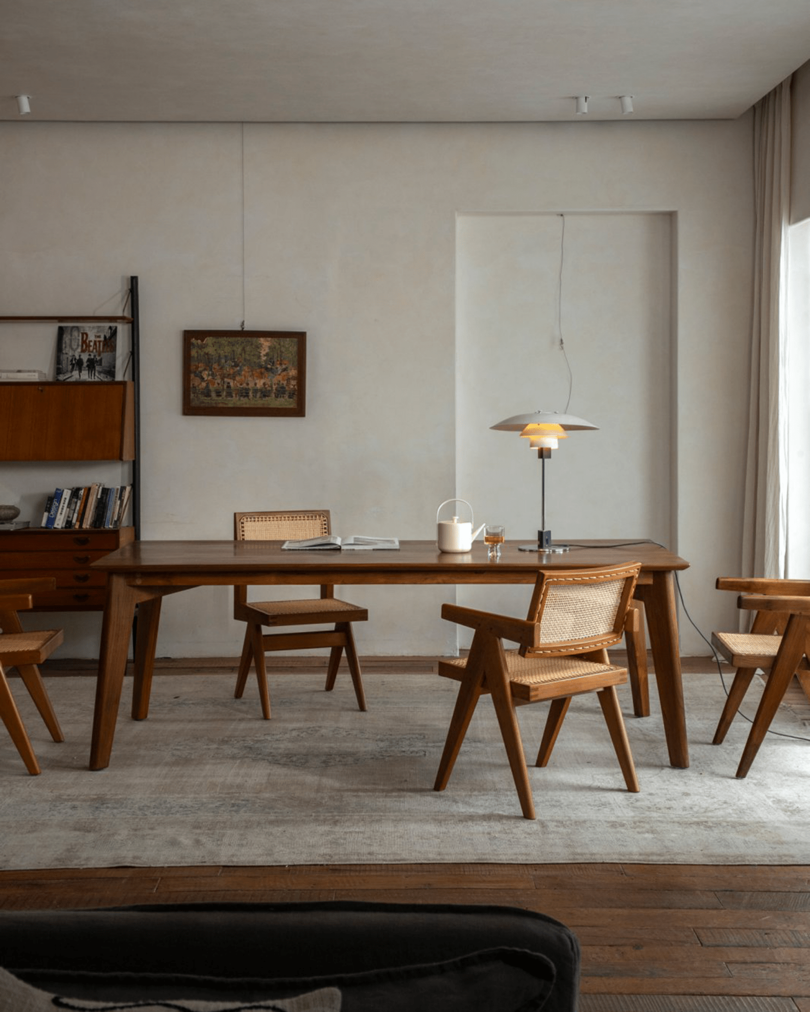 Easy Dining Table in a minimalist dining room with wooden chairs and lamp, natural wood color, versatile dining space