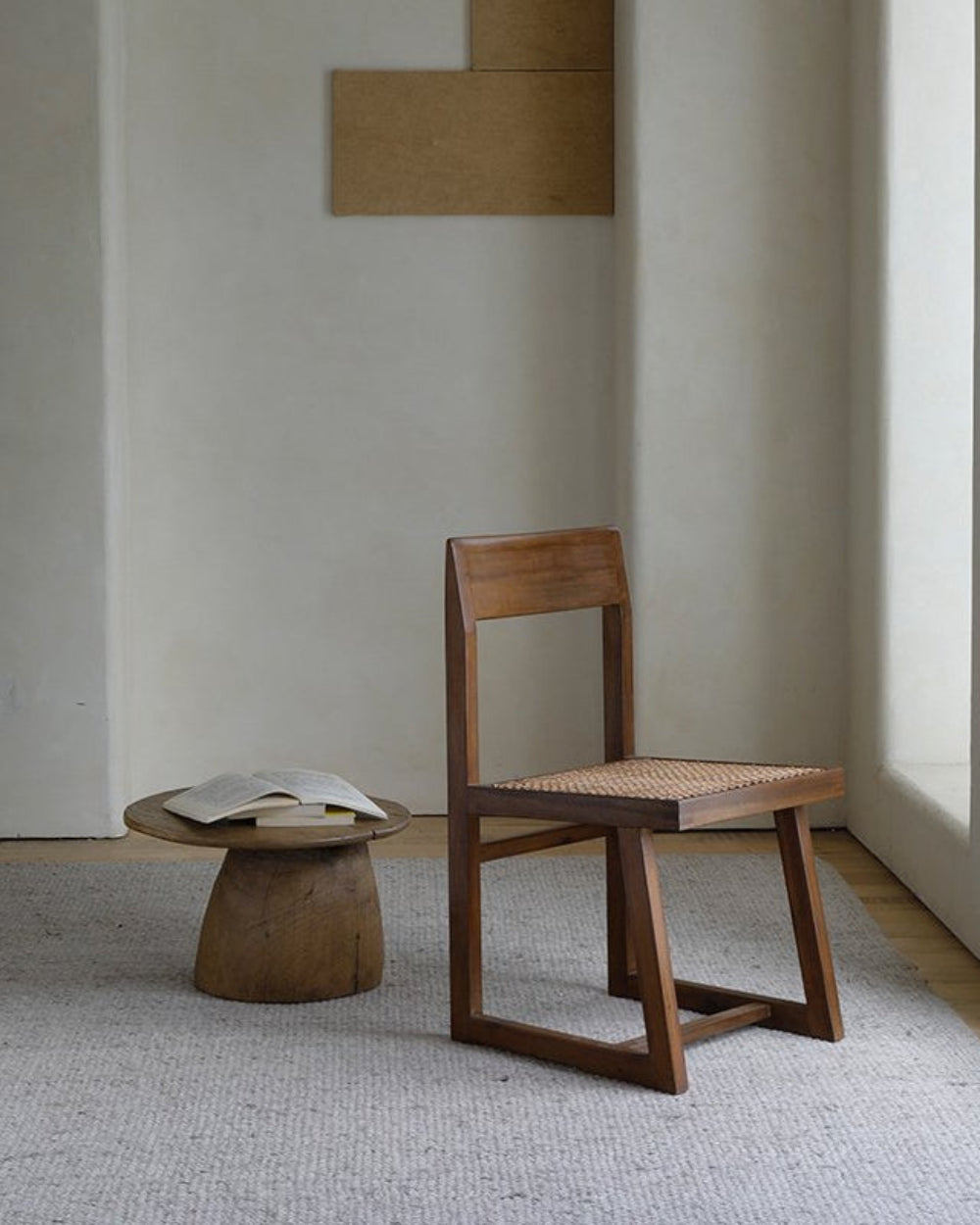 Chandigarh Box Chair in interior setting with woven seat and wooden frame, mid-century modern design