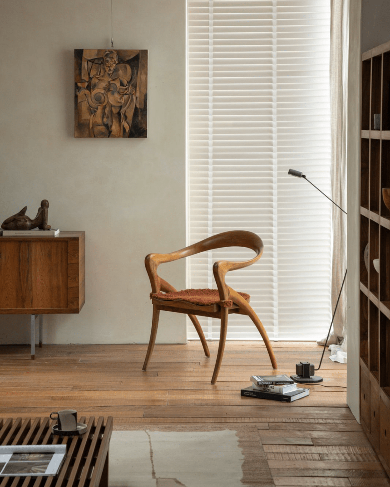 Olivia Chair in modern living room setting, solid teak wood, curved back, modern design