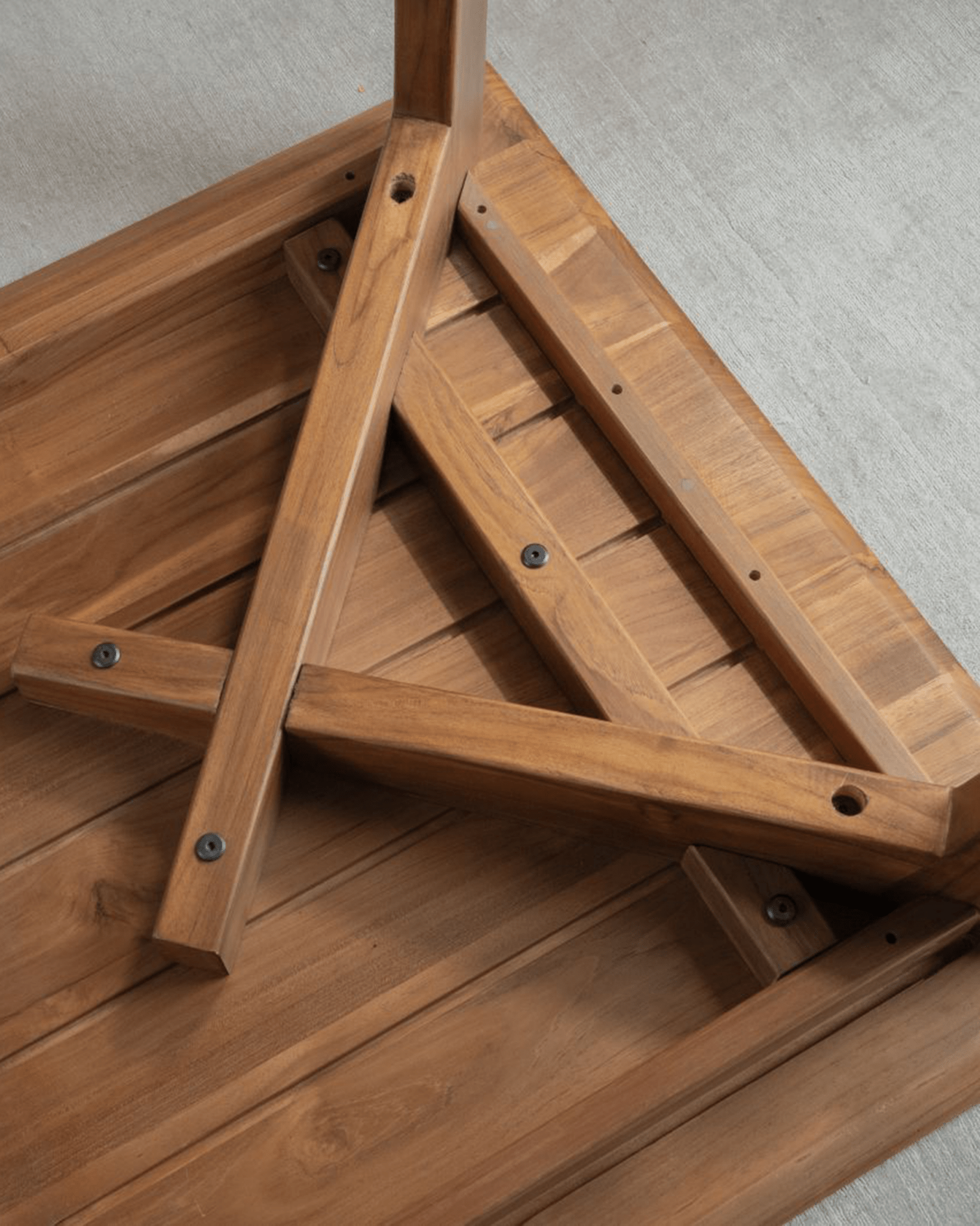 Easy Dining Table underside detail: African teak wood construction, showing joints and leg structure, minimalist design