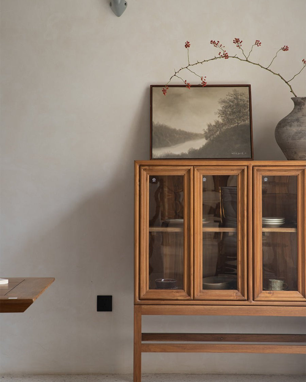 Teak wood Stilt Cabinet, three glass doors, interior view of dishes.
