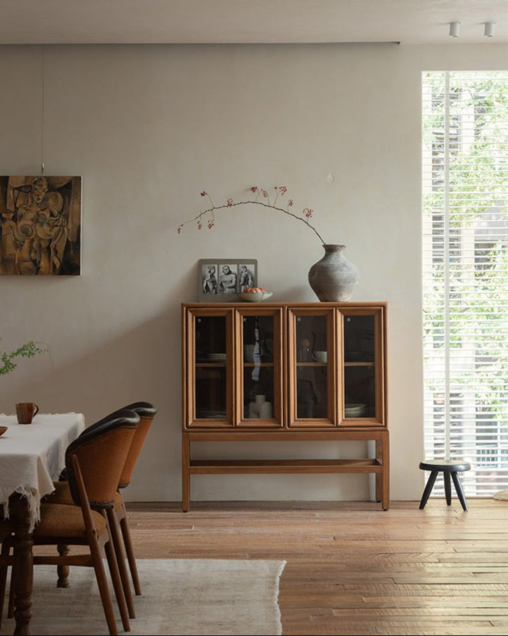 Teak wood Stilt Cabinet with glass doors in a dining room, elegant display and storage solution