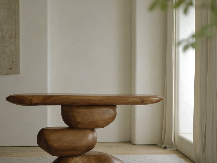 Unique wooden console table with rounded top and organic base in bright interior
