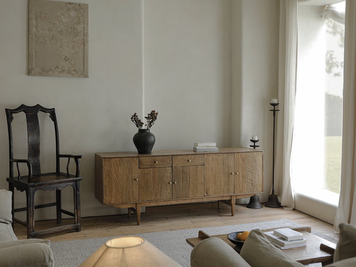 OX Sideboard in a minimalist living room, vintage aged wood, warm feel, with a black vase on top.