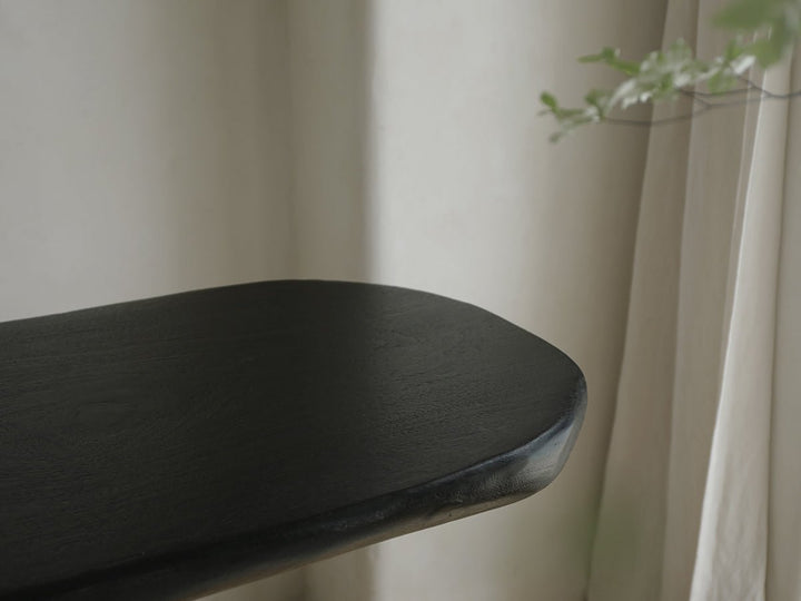 Elegant black console table with soft curves and a minimalist design