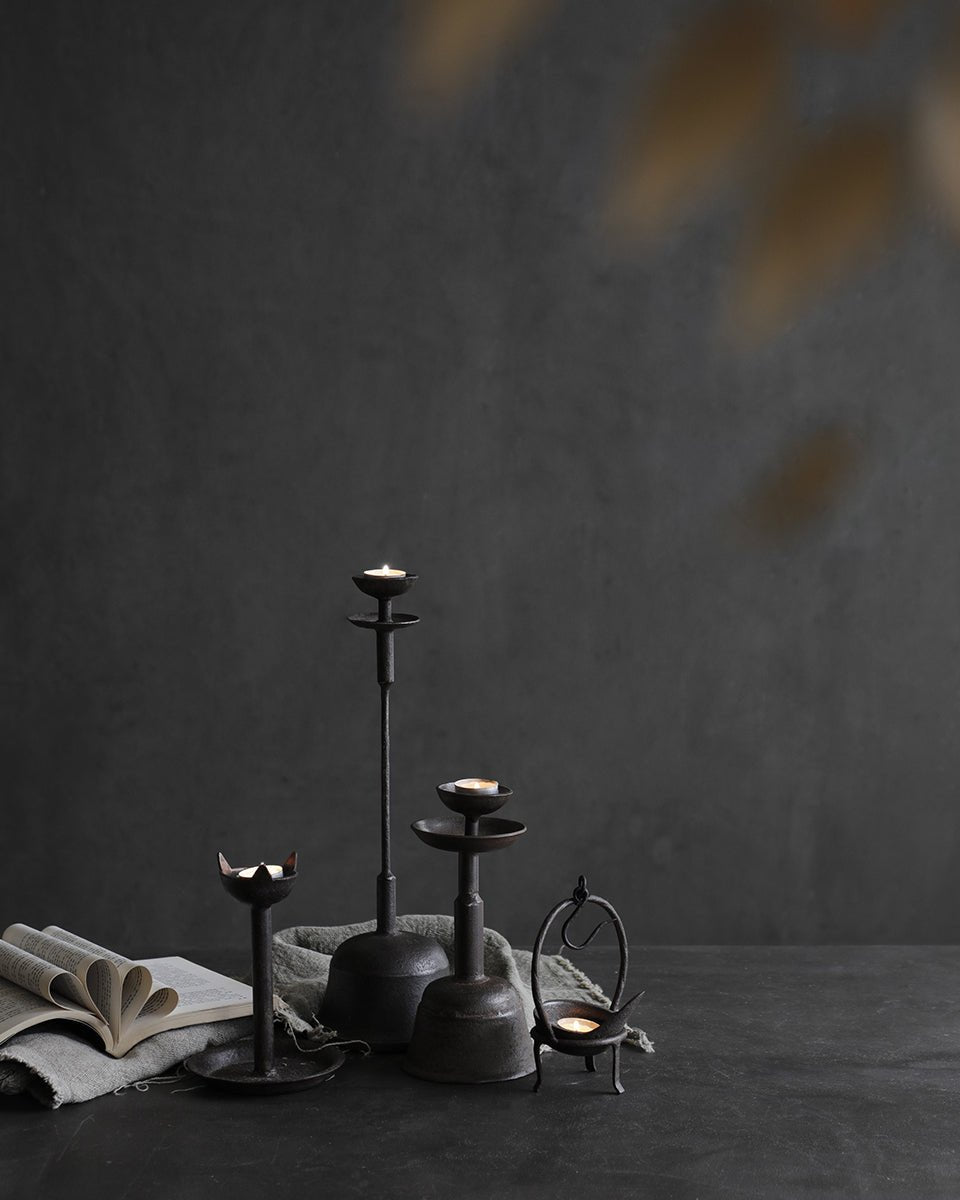 Rustic Iron Candle Holder Set with lit candles, creating a warm, inviting ambiance for home décor