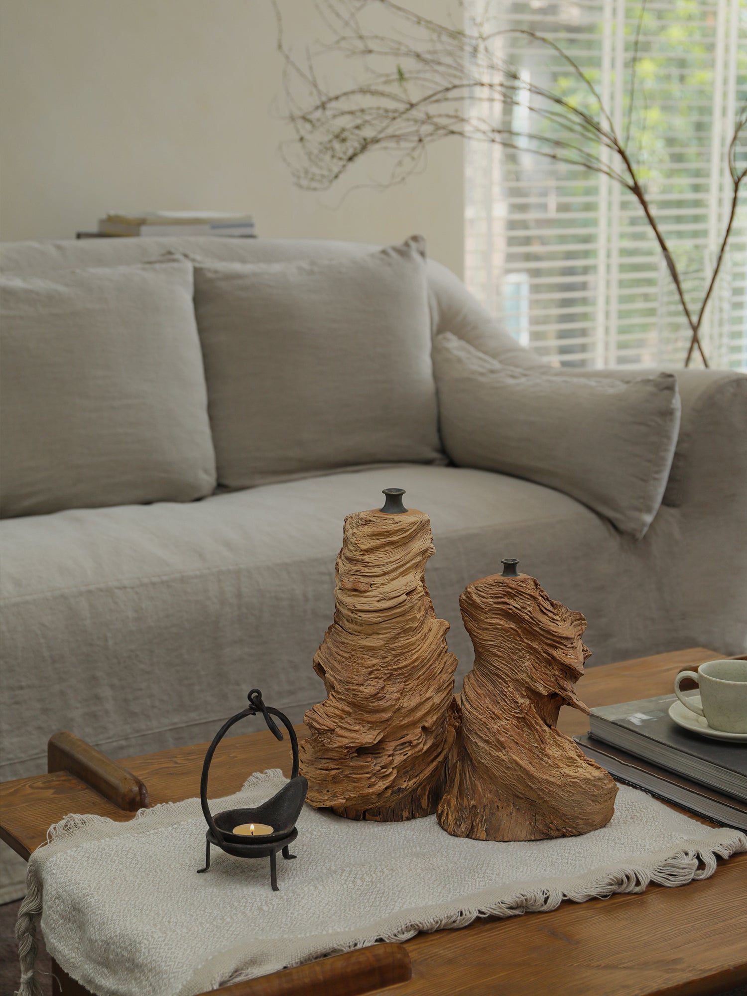 Two unique wooden wavy vases on a wooden table. Handcrafted vases with natural wood grain, perfect for home decor.