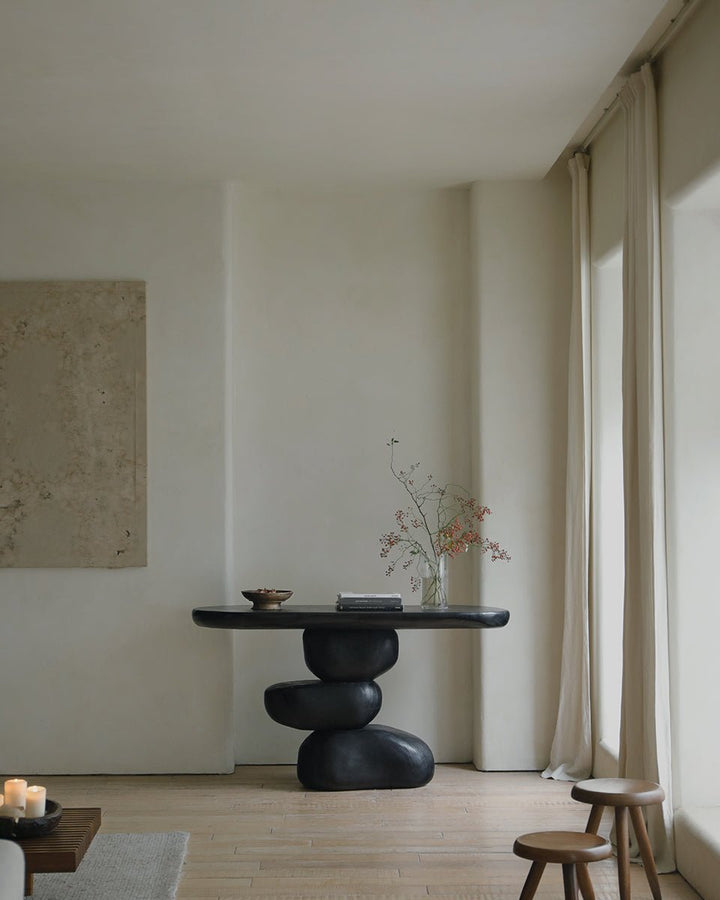 Black console table with flowing design in minimalist living space