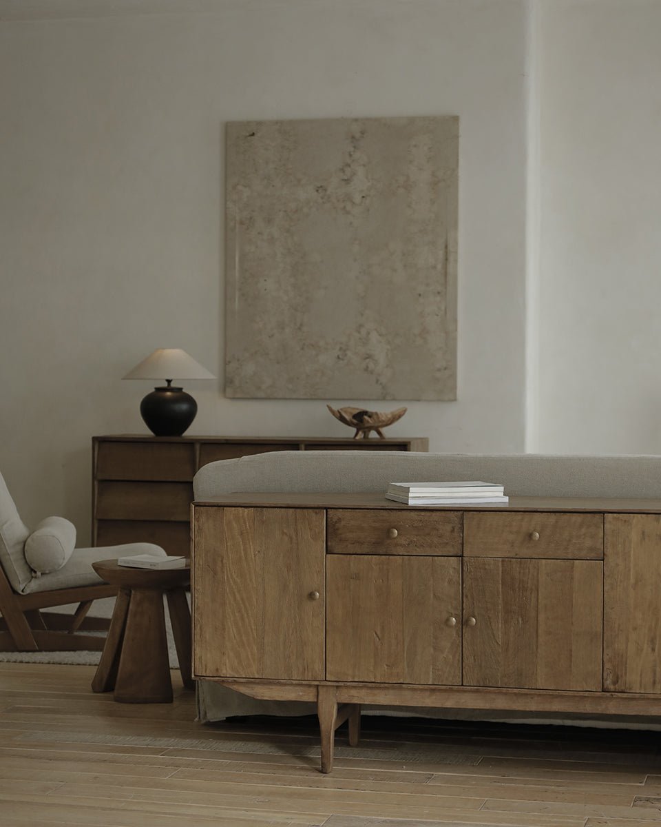 OX Sideboard in a minimalist living room setting with vintage aged wood, brass handles, and warm ambiance.