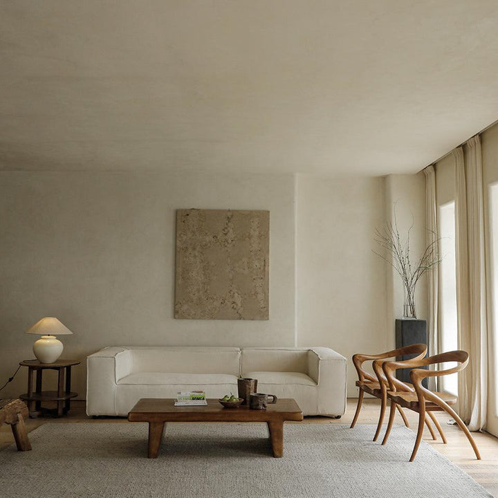 Modern living room with beige sofa, Olivia Chairs, and natural light.