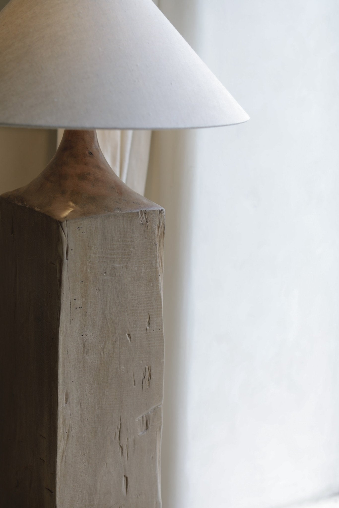 Close-up of a wooden floor lamp base and linen shade. Chinese Plug Type A. Minimalist wooden lamp for cozy lighting.