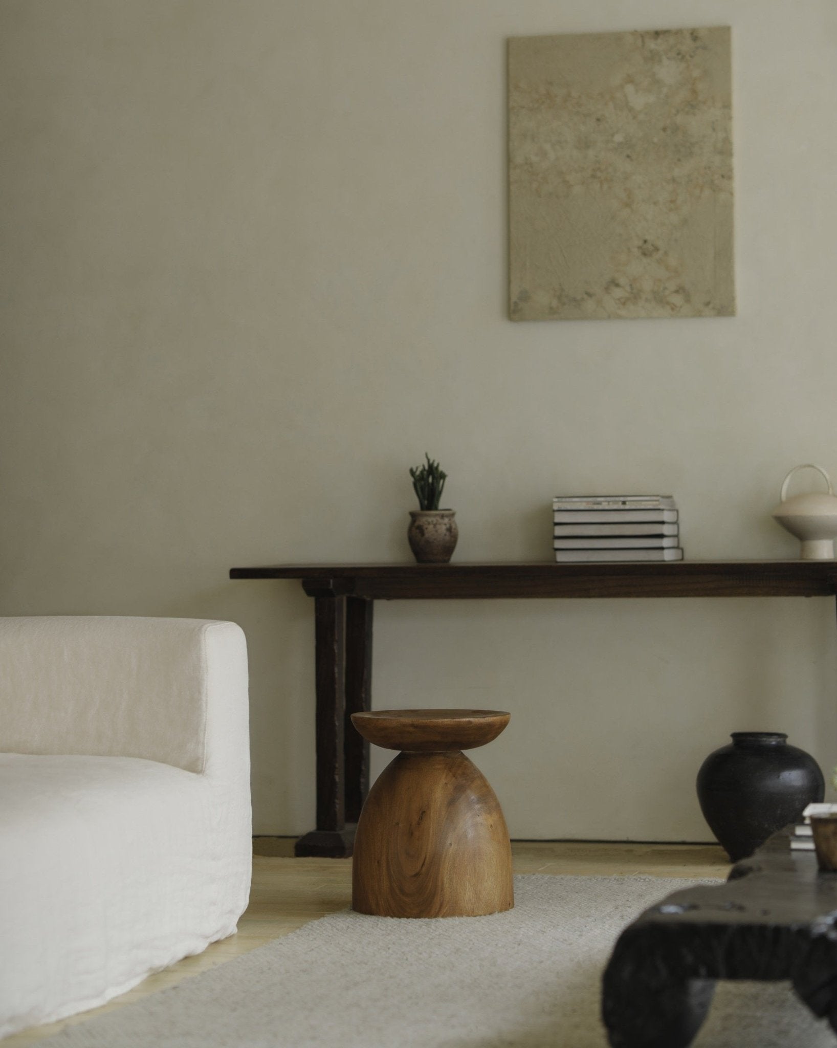 Wooden Samanea saman side table with minimalist design, sofa and decor