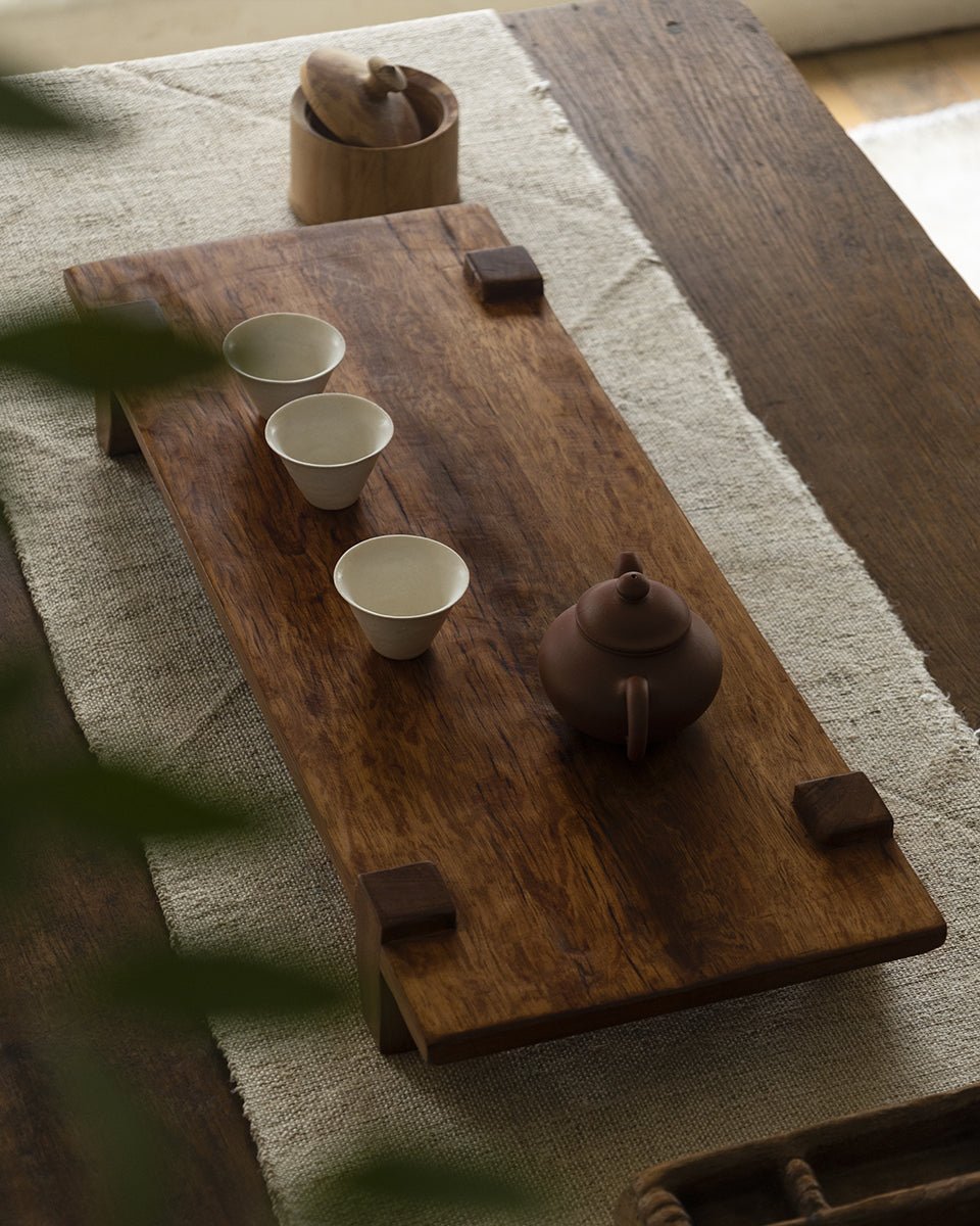 Chinese tea tray made of reclaimed wood with tea cups and teapot, rustic design