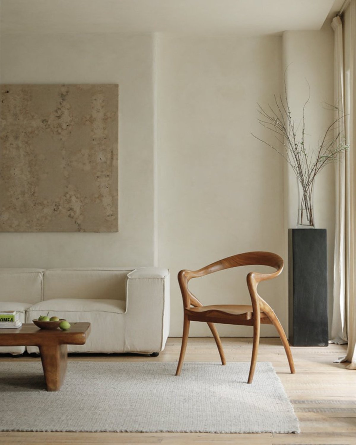 Olivia Chair in a modern interior setting. Solid teak wood, curved back, contoured seat, modern design.