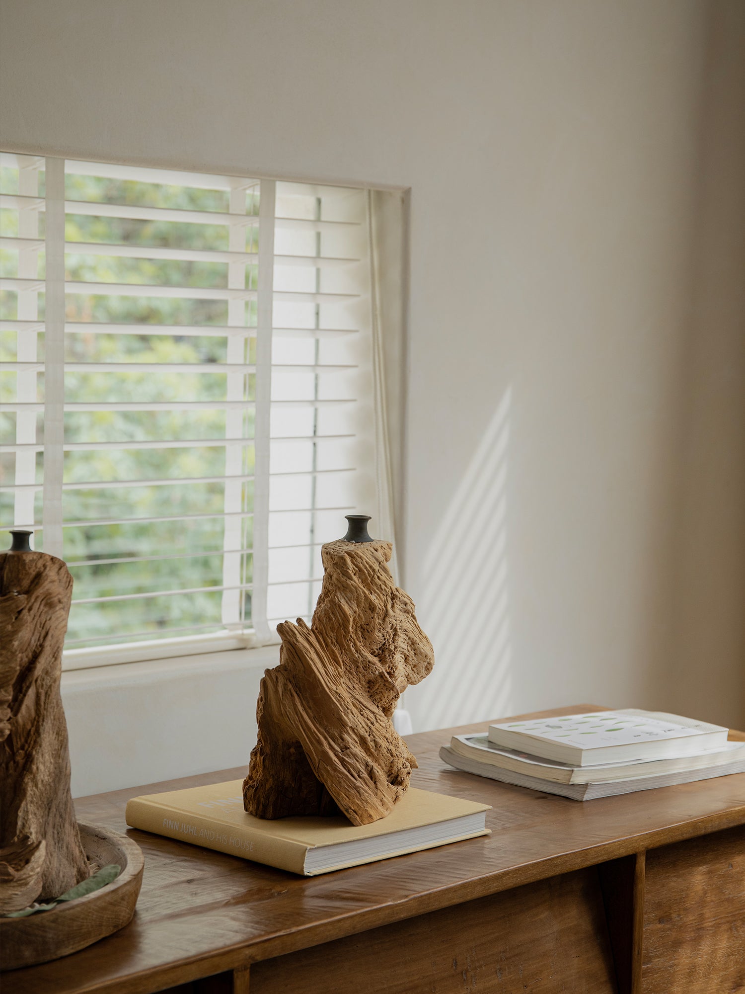 Wavy wooden vase with natural wood grain on a wooden table, perfect for home decor, book "Finn Juhl and His House".