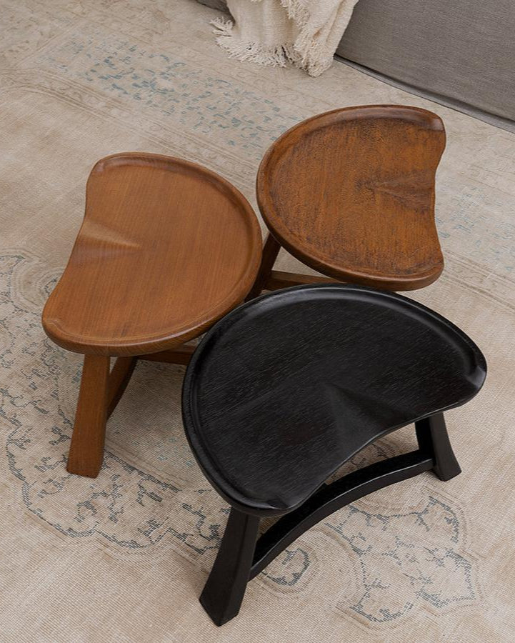 Pod Stool set in natural wood, vintage, and carbonized black finishes, ideal for vintage or modern living spaces