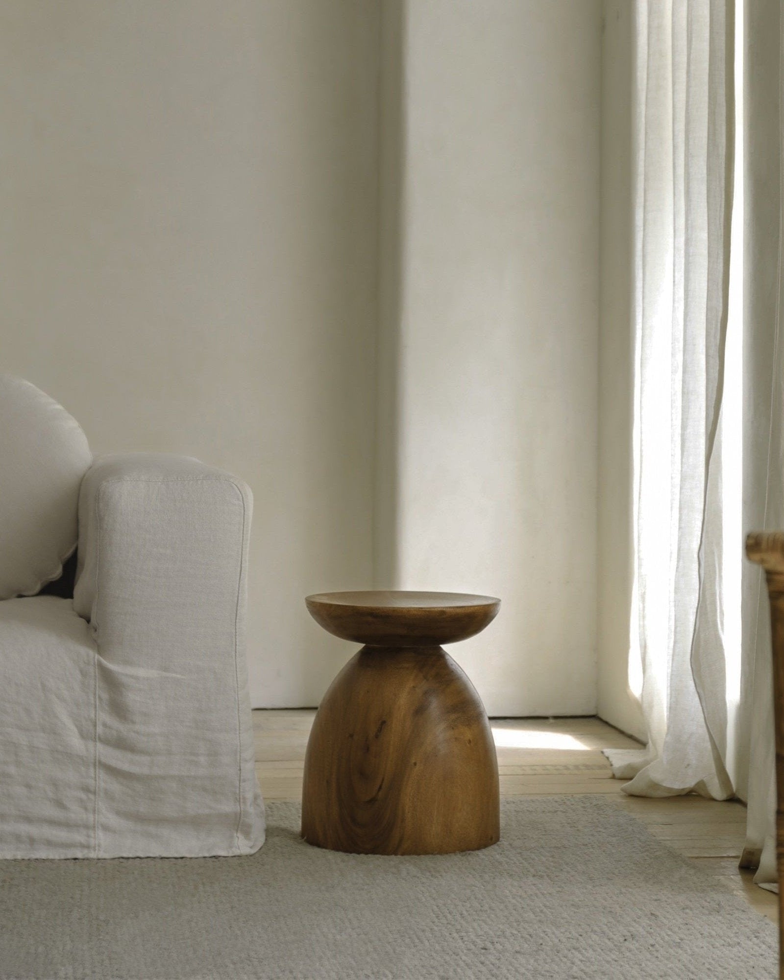 Sandglass table made of Samanea saman, brown wooden accent table, minimalist decor.