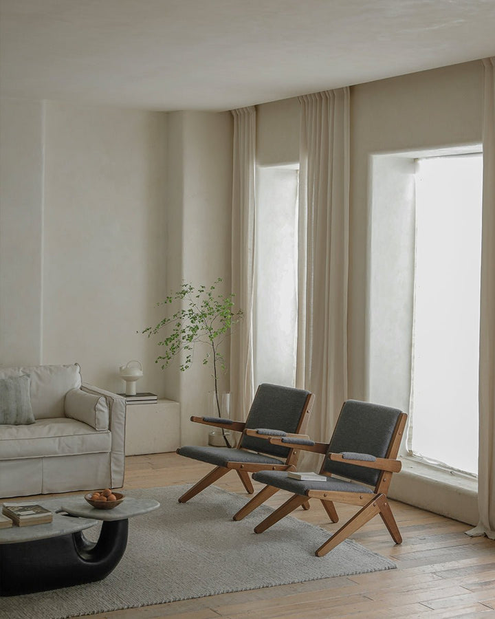Scissors Chairs with gray upholstery in a modern living room design setting.