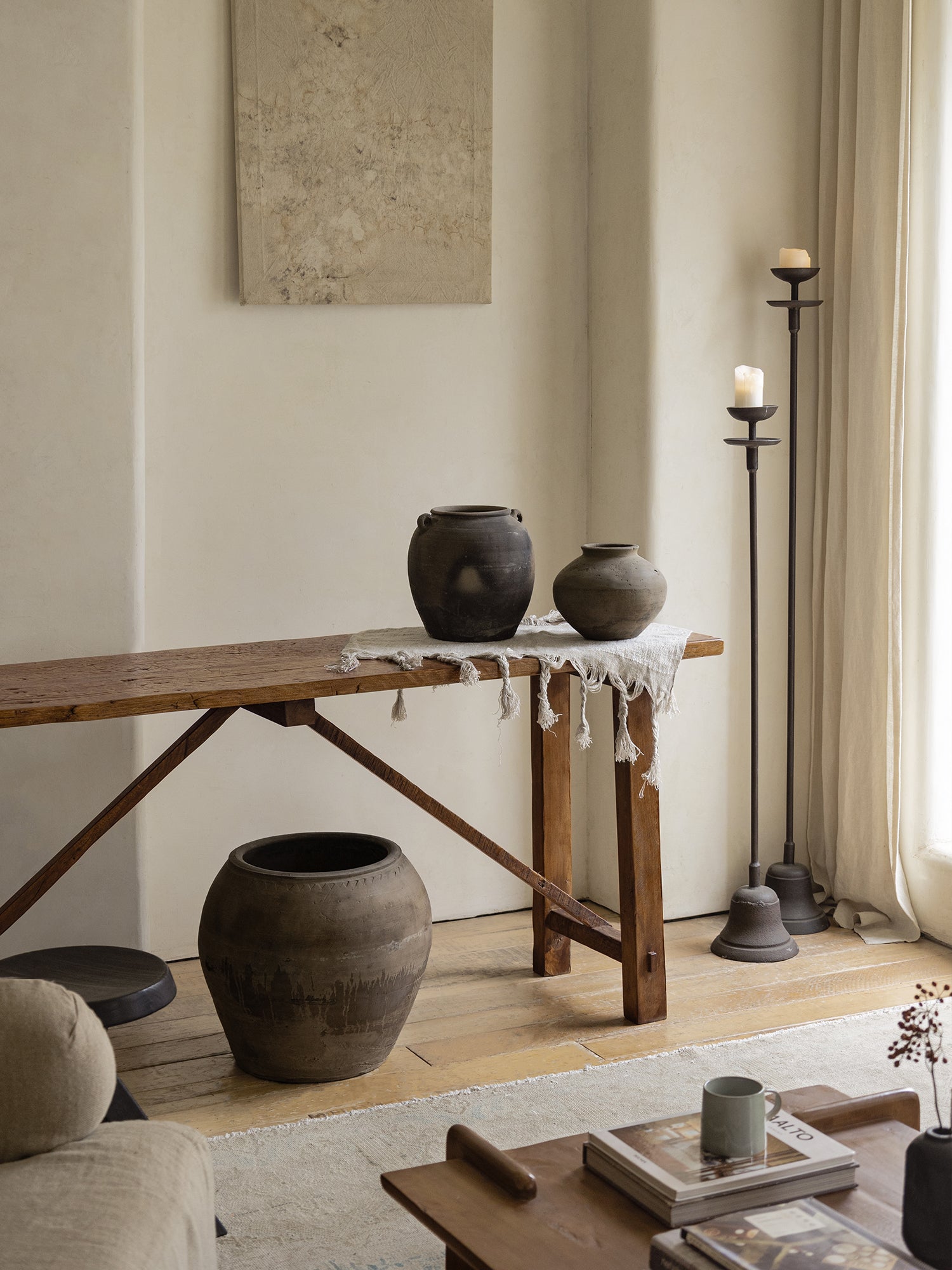 Clay pots in various sizes and colors, displayed on a rustic wooden table, perfect home decor. A combination of old and new.