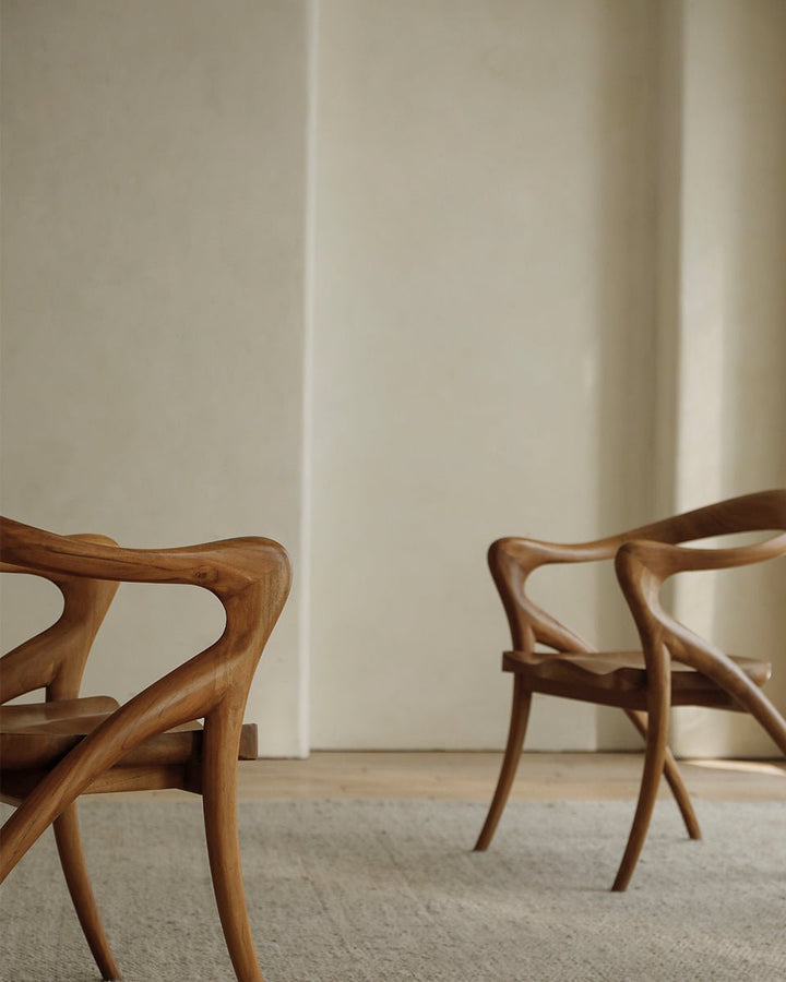 Olivia Chairs with elegant curves in a serene, neutral-toned interior.