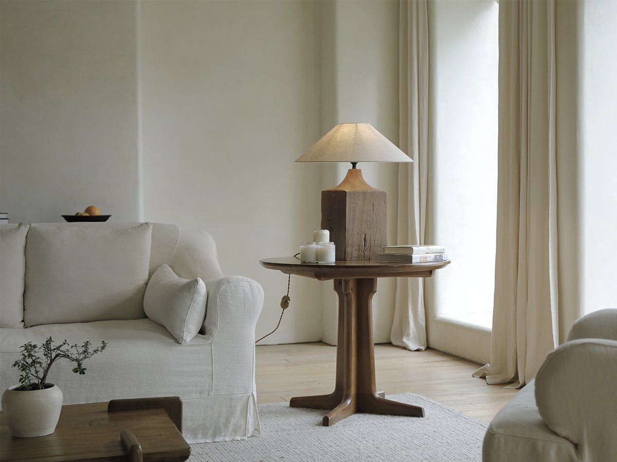 Wooden table lamp with linen shade in cozy living room, neutral aesthetic