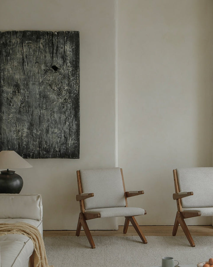 Stylish gray Scissors Chairs with wooden frames in a cozy living room setting