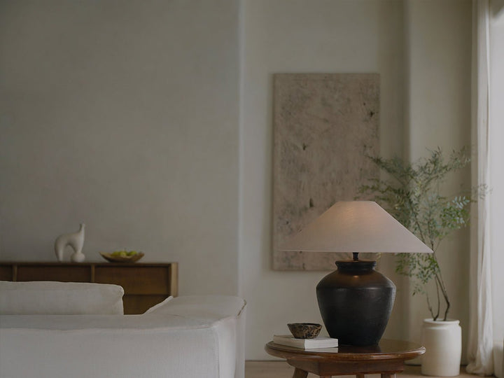 Stylish shirt lamp on table with minimalist decor and soft lighting.