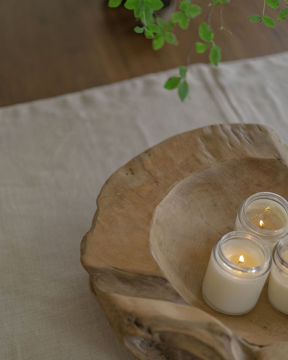Indonesian Teak wooden platter with three candles. Handmade decorative display.