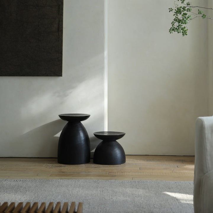 Black Sandglass Tables in a minimalist living room with soft textures and natural light.