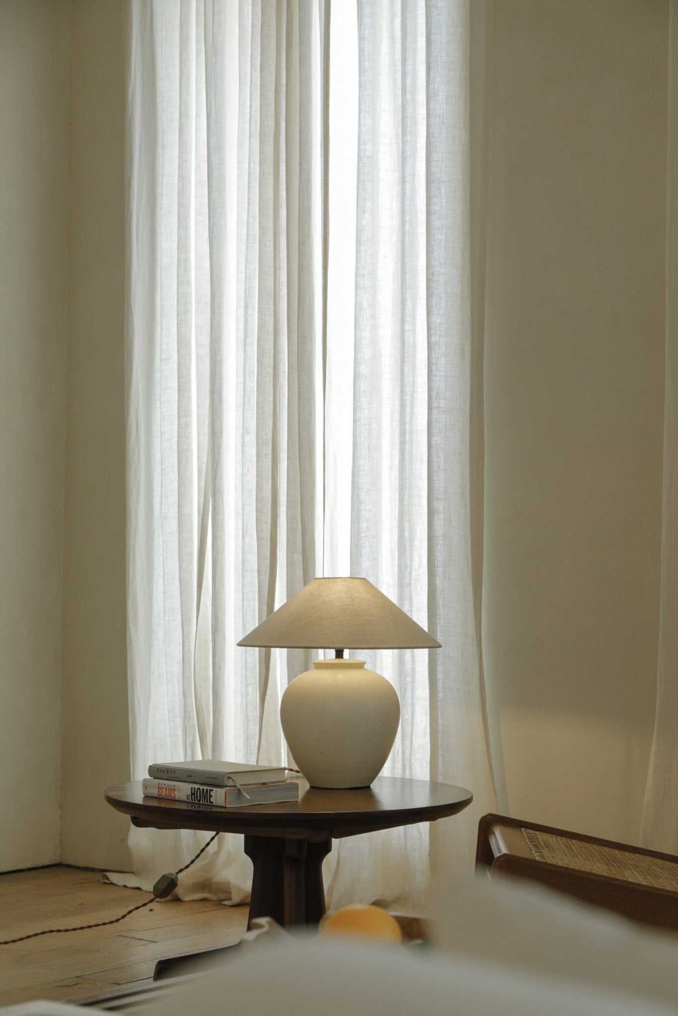 Clay Egg Lamp on wooden table with BEAMS AT HOME books, interior decor